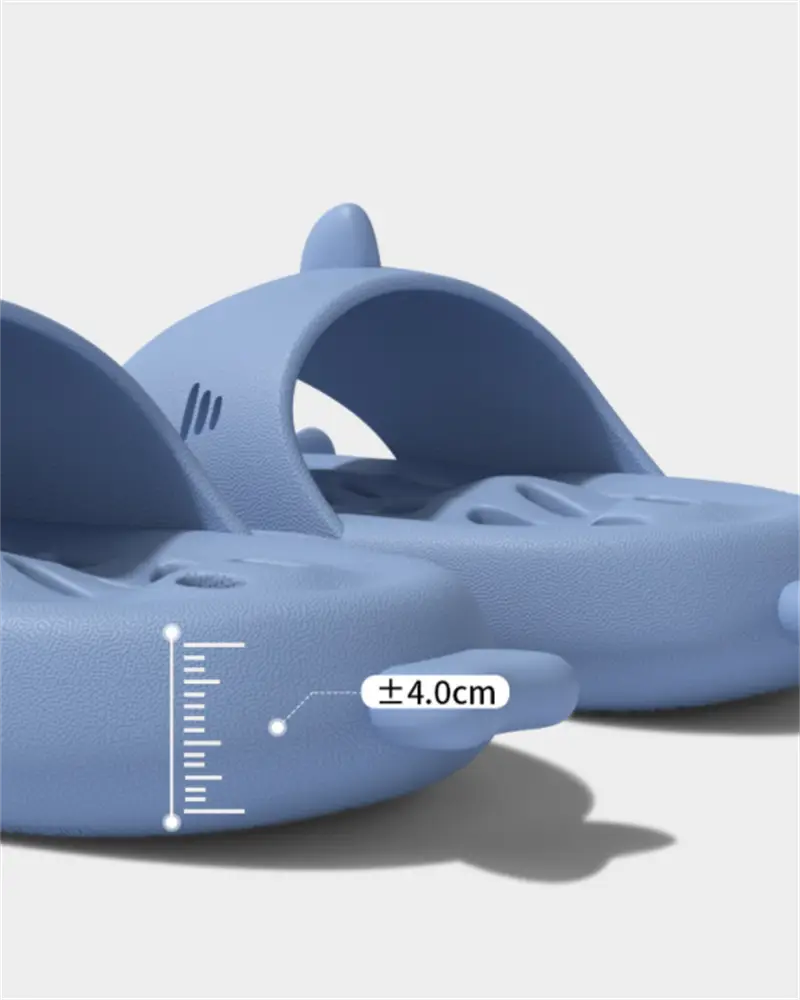 Light blue shark-shaped quick dry non slip shower slides made of smooth molded plastic.