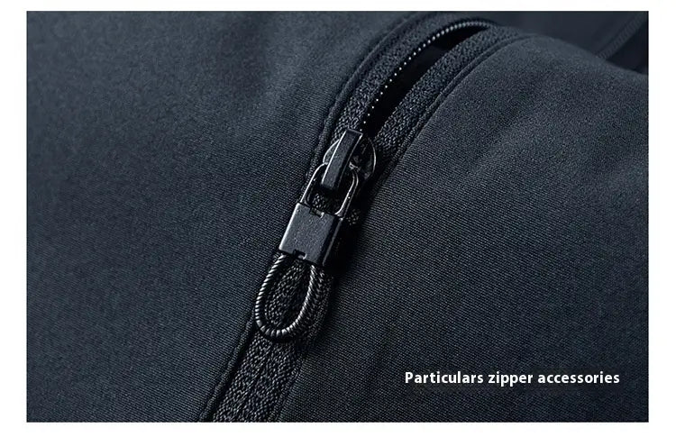 Black zipper with a sleek metal pull tab and braided cord loop on a men casual jacket lightweight outdoor windbreaker made of dark fabric.