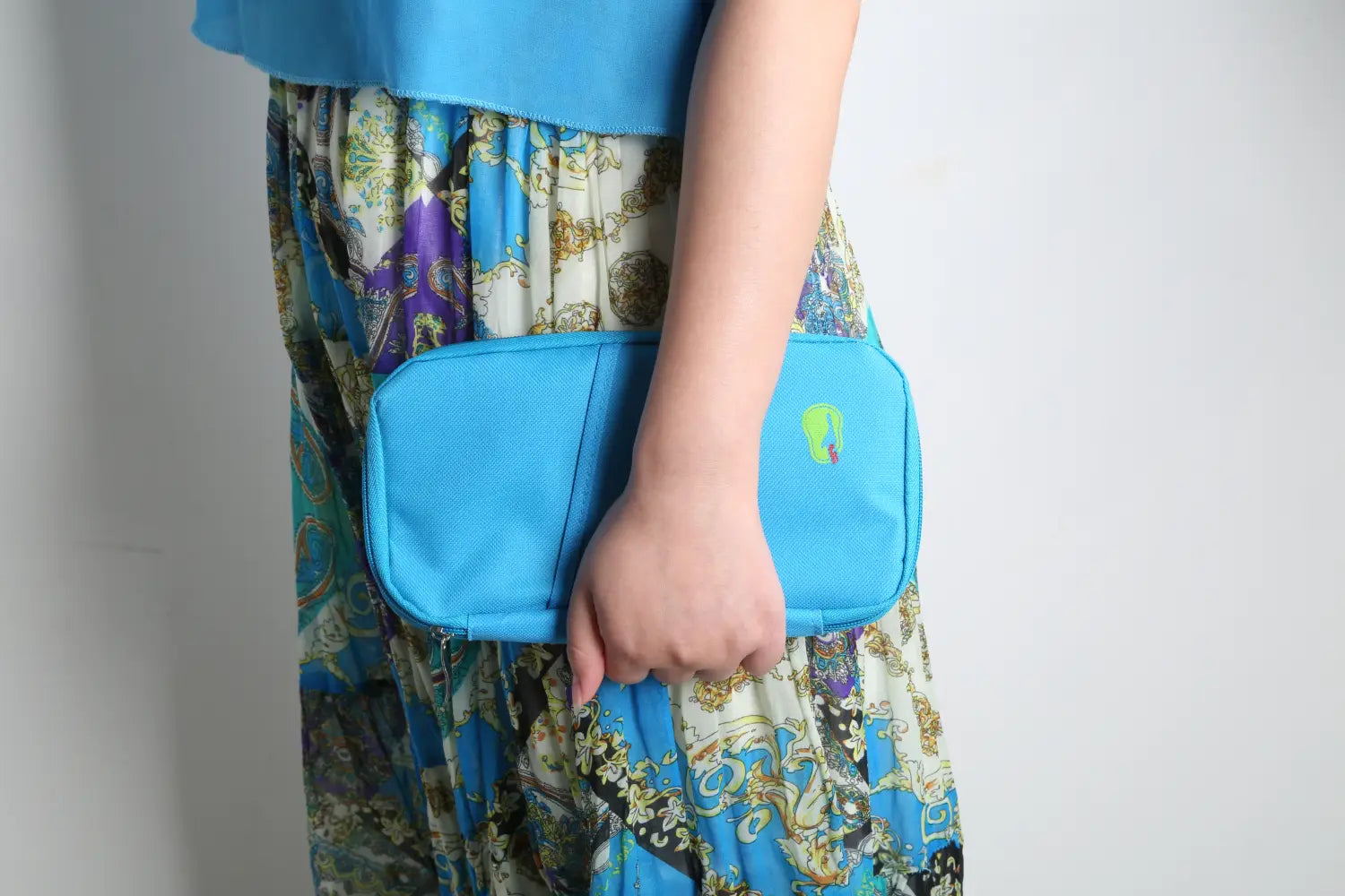 Bright blue rectangular waterproof oxford fabric travel passport and document wallet with a subtle textured surface and a small green logo on the front.
