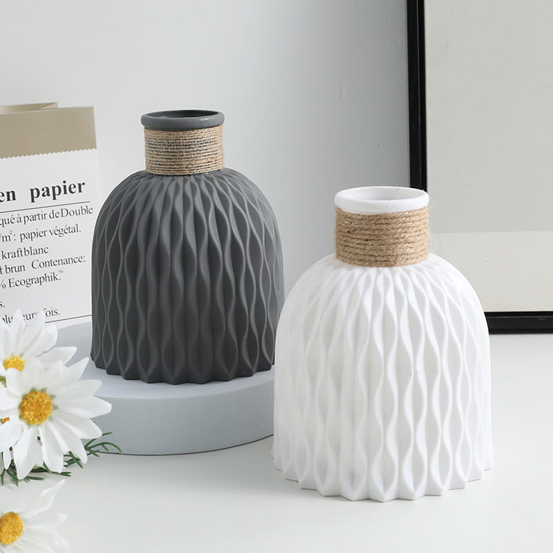 Two ceramic vases with wavy textured surfaces in matte gray and white featuring natural twine-wrapped necks from a ceramic vase set with twine and wavy texture 4 pack.