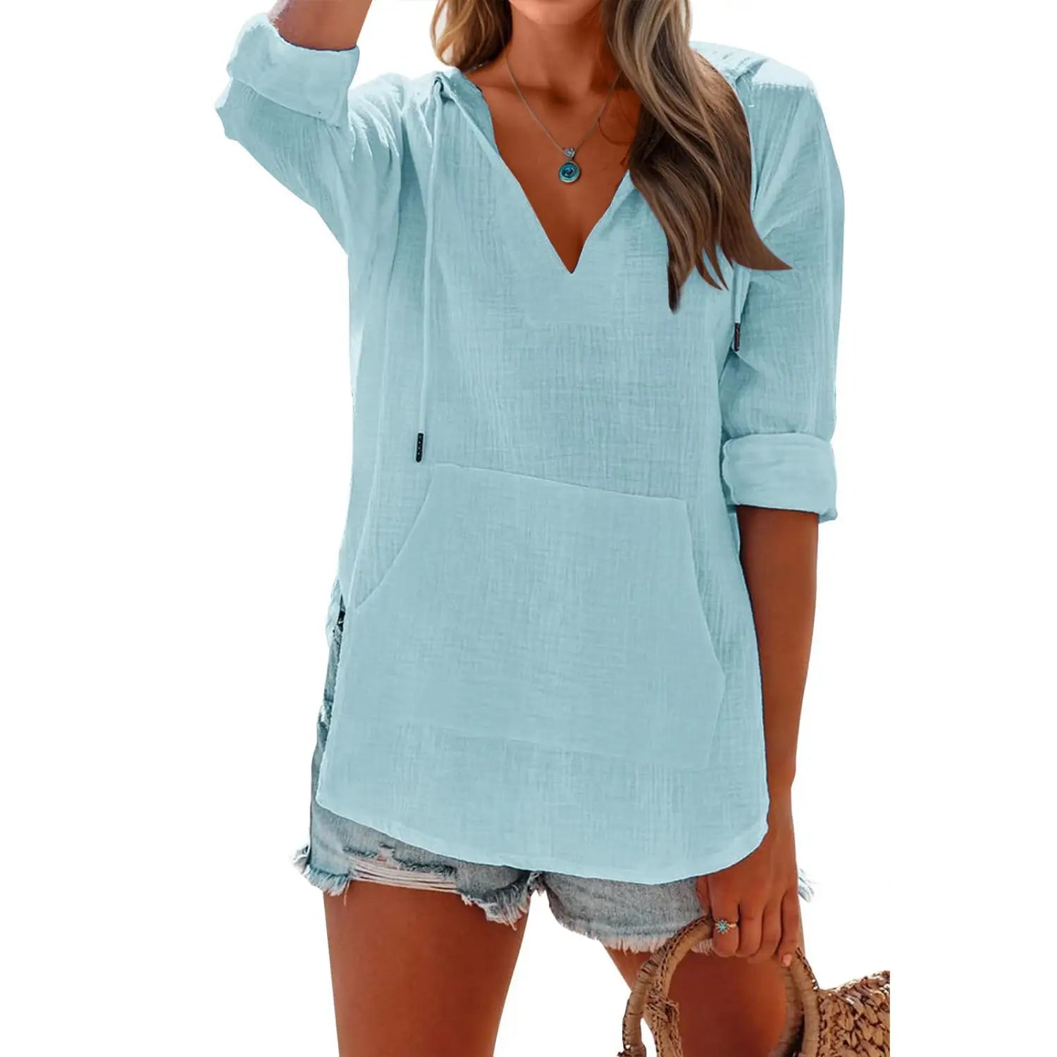 Light blue textured linen blouse with v neck and rolled sleeves for women made from cotton linen blend.