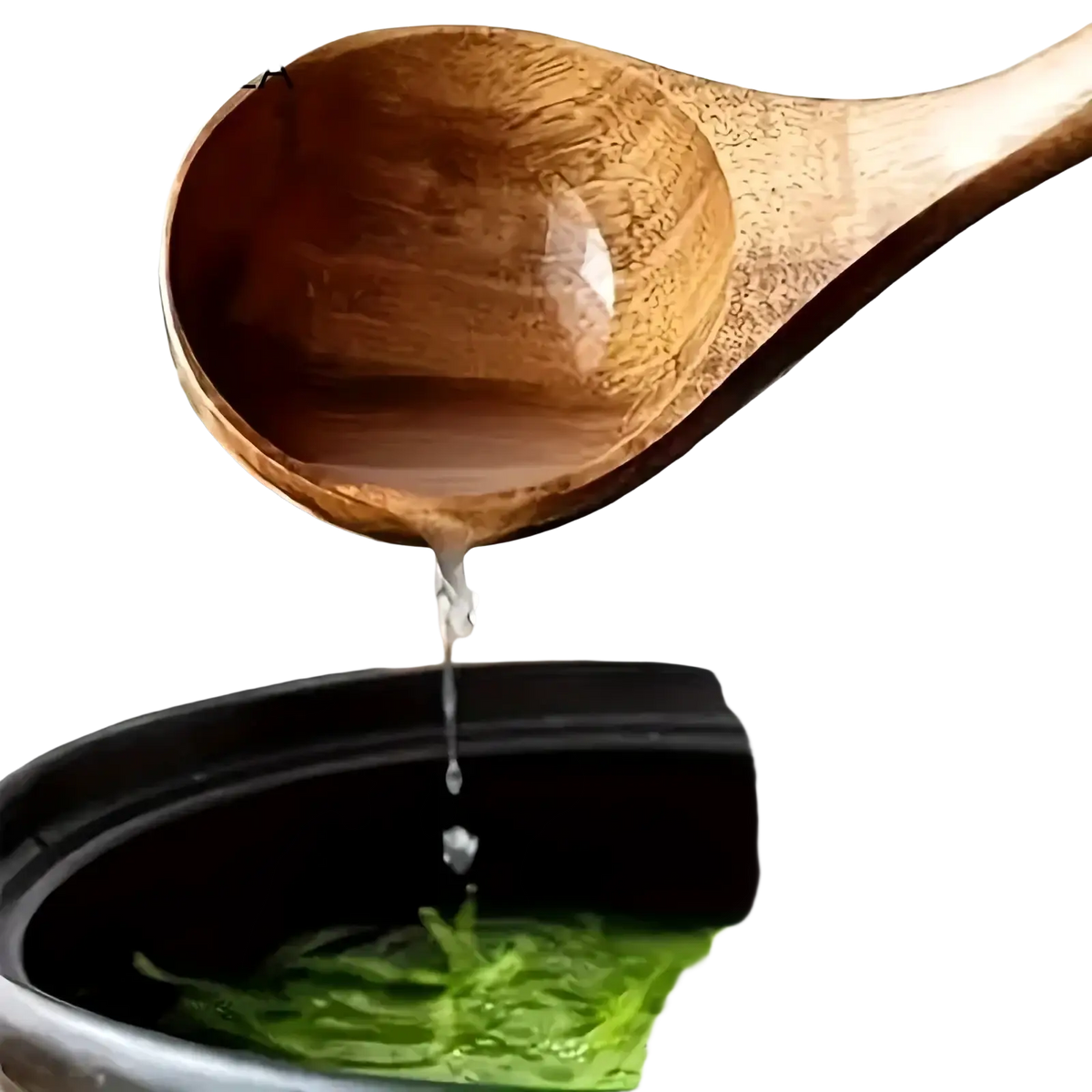 A smooth light brown acacia wood spoon with glossy finish drizzling golden honey into green noodles in kitchen set