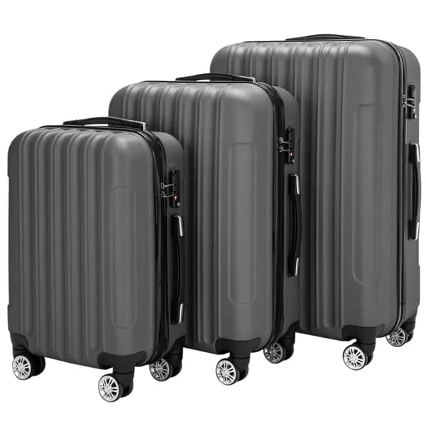 Set of three dark gray hard shell spinner suitcases with vertical ridges and silver toned wheels in a 3-in-1 luggage set.