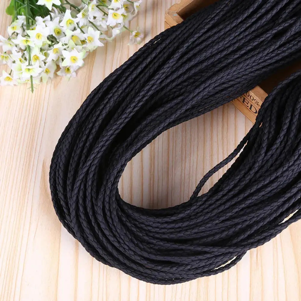 Black braided cord decorative rope made of durable material neatly coiled on wooden surface for diy fashion projects