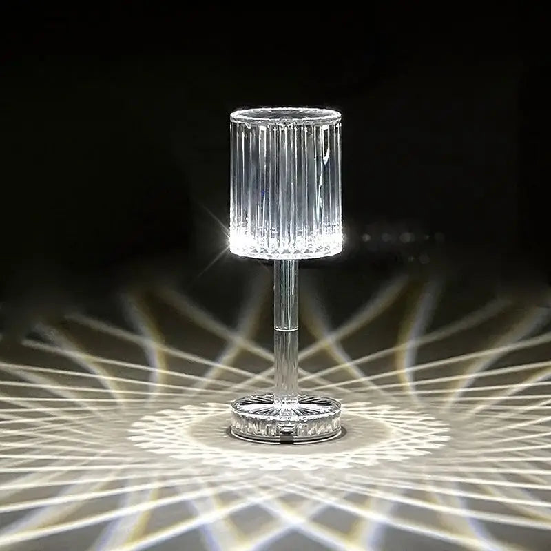 Crystal table lamp with clear ribbed glass, a slender stem, and a crystal base featuring 3 way dimmable touch control for night light use.