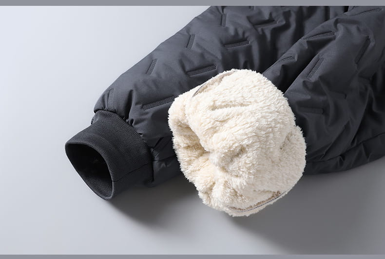 Thermal fleece lined winter joggers in dark gray quilted fabric with cream-colored plush fleece lining visible at the cuff.