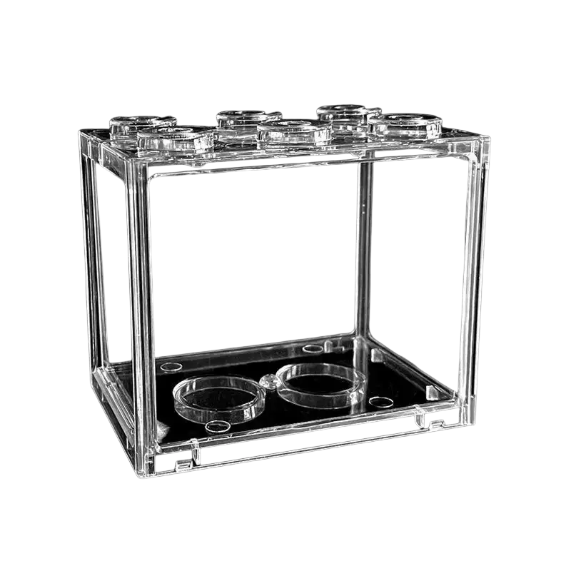 Clear acrylic betta fish tank designed as a stackable lego brick style mini aquarium with circular indentations