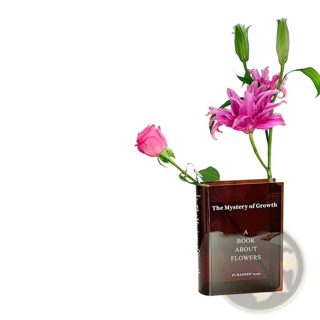 Acrylic translucent amber book-shaped vase titled the mystery of growth holding pink lilies and a rose for home decor