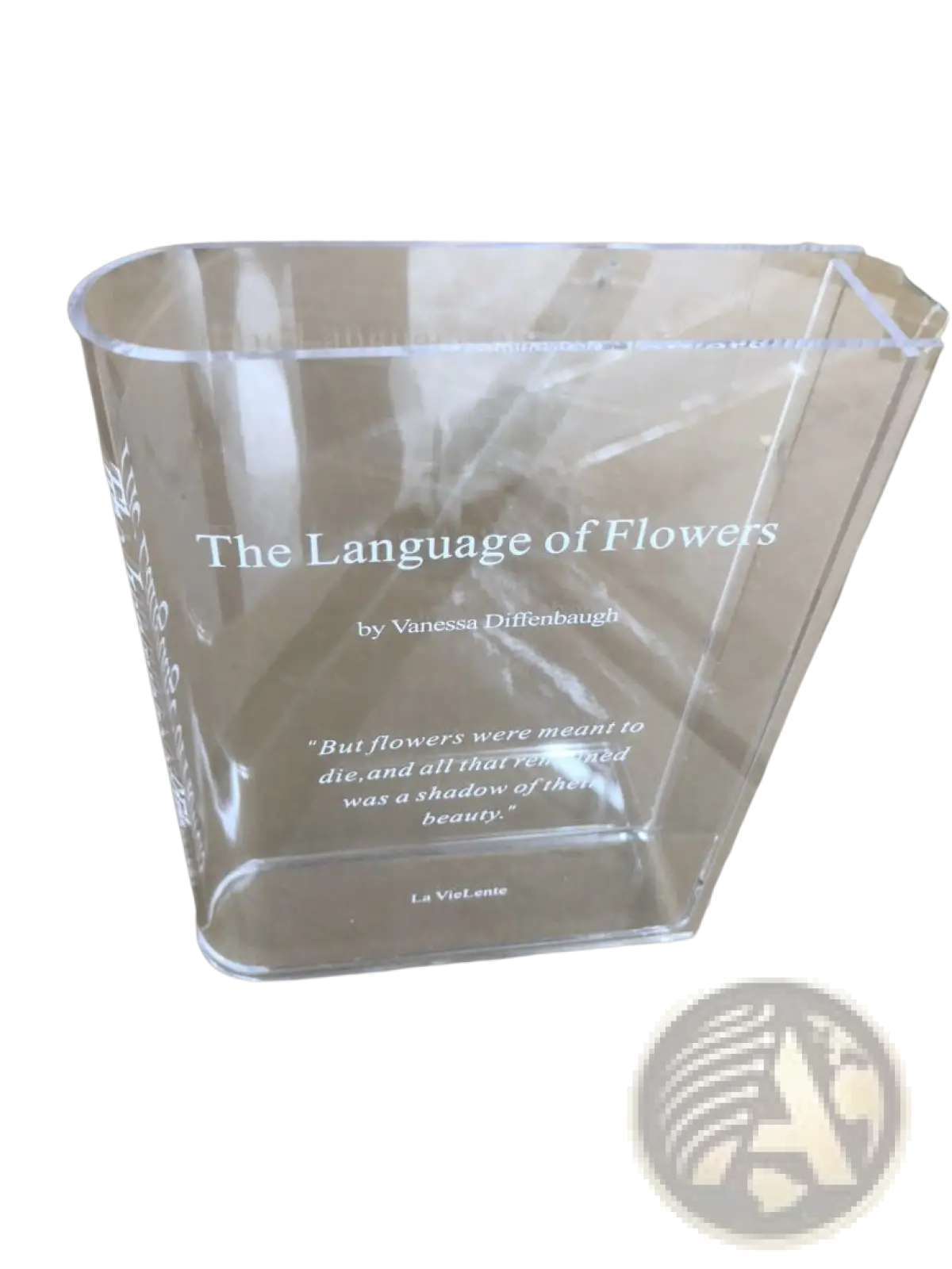 Clear acrylic book flower vase with engraved text from the language of flowers by Vanessa Diffenbaugh modern decor