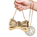 Gold metallic acrylic bow crossbody clutch bag with chain strap in metallic gold and silver finish