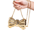 Gold metallic acrylic bow crossbody clutch bag with chain strap in metallic gold and silver finish