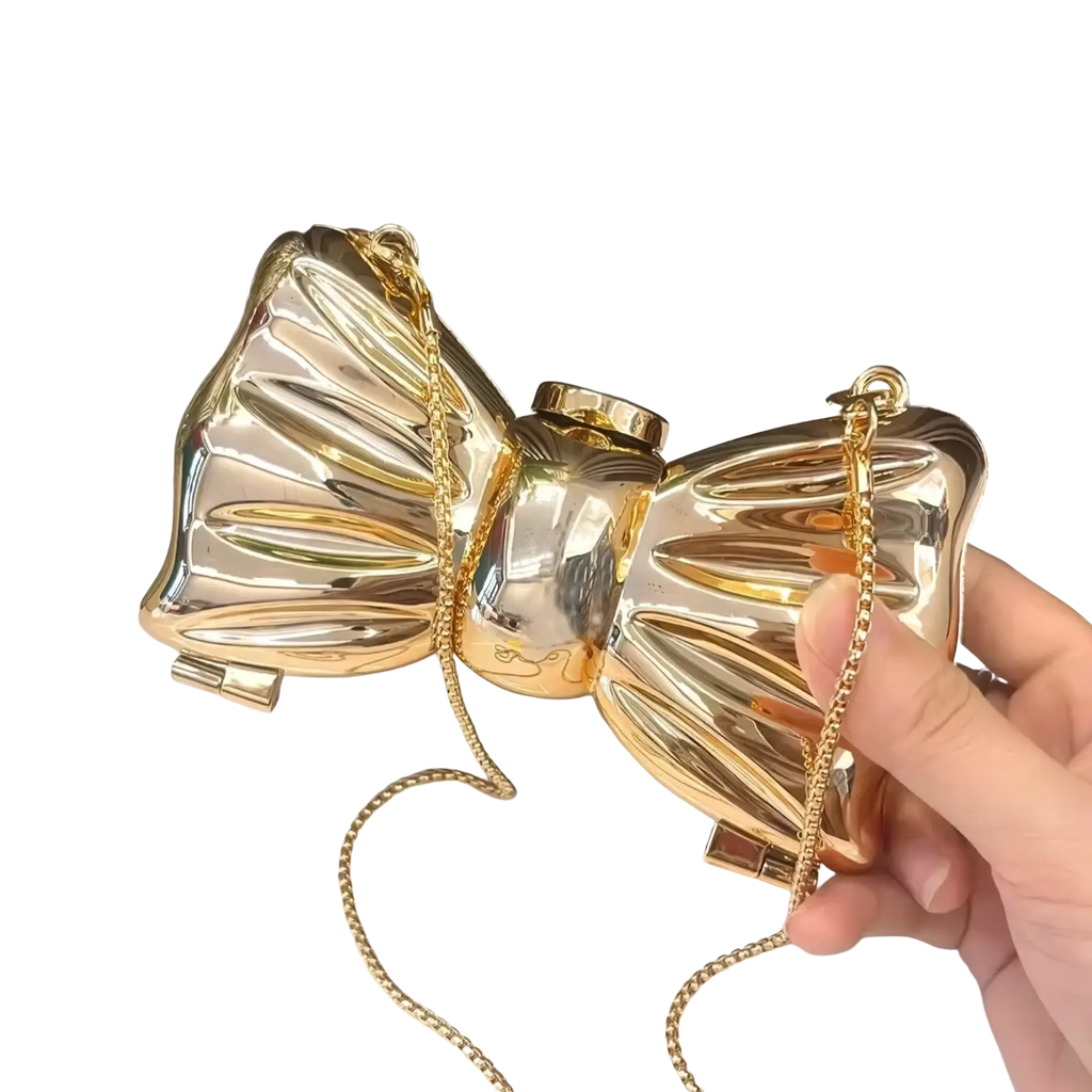 Shiny gold metallic acrylic bow crossbody bag with a chain strap perfect as a clutch for elegant occasions