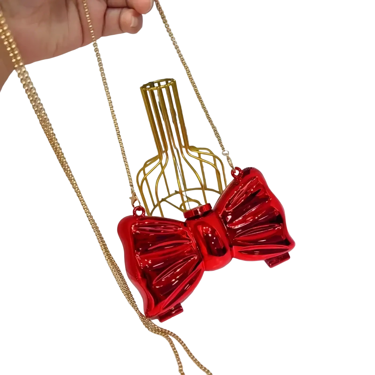 A shiny red acrylic bow crossbody bag with a gold chain strap suitable as a metallic gold silver clutch