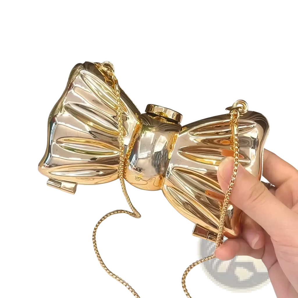 Shiny gold metallic acrylic bow crossbody bag with a chain strap perfect as a clutch for elegant occasions