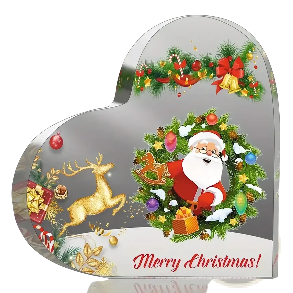 Clear acrylic heart-shaped christmas ornament with santa claus, green wreath, gold reindeer, and holiday decorations on desktop stand