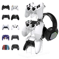 Clear acrylic gaming controller stand and headset holder displaying multiple white PlayStation controllers and a black RGB headset
