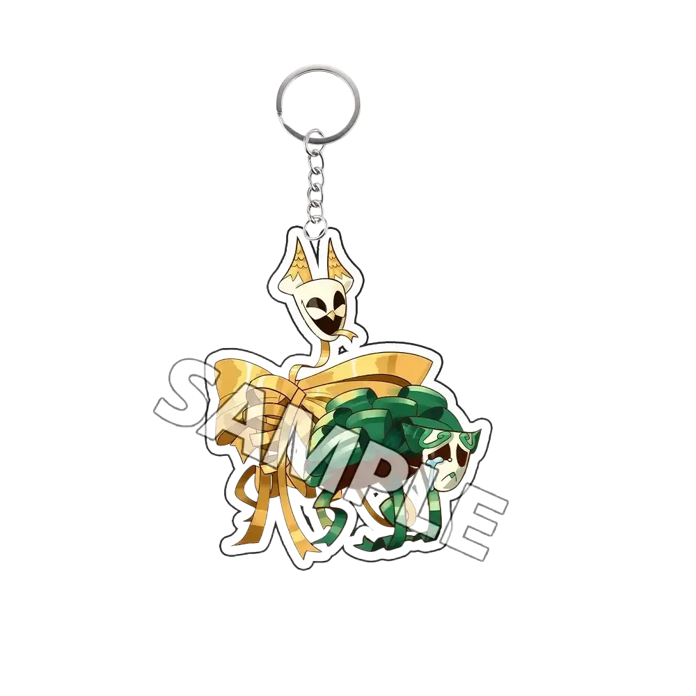 Acrylic keychain featuring two cartoon skulls with gold horns and green ribbon tied by a gold bow finished goods