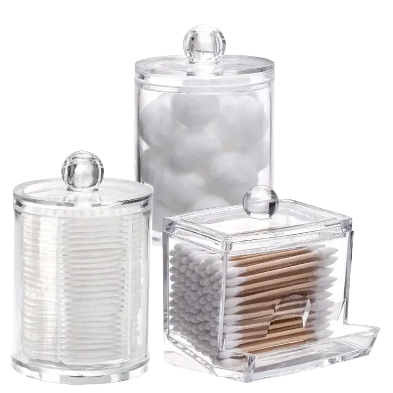 Clear acrylic q-tip and cotton ball storage jar set with spherical glass lids holding cotton balls and q-tips