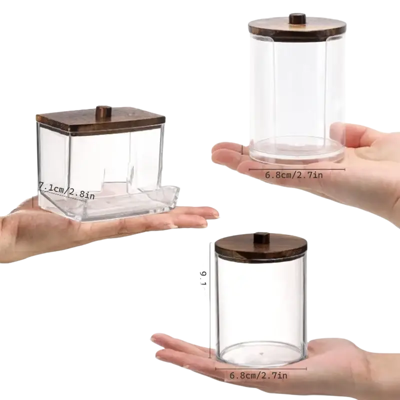 Clear glass acrylic q-tip and cotton ball storage jars with dark brown wooden lids and central knob tops