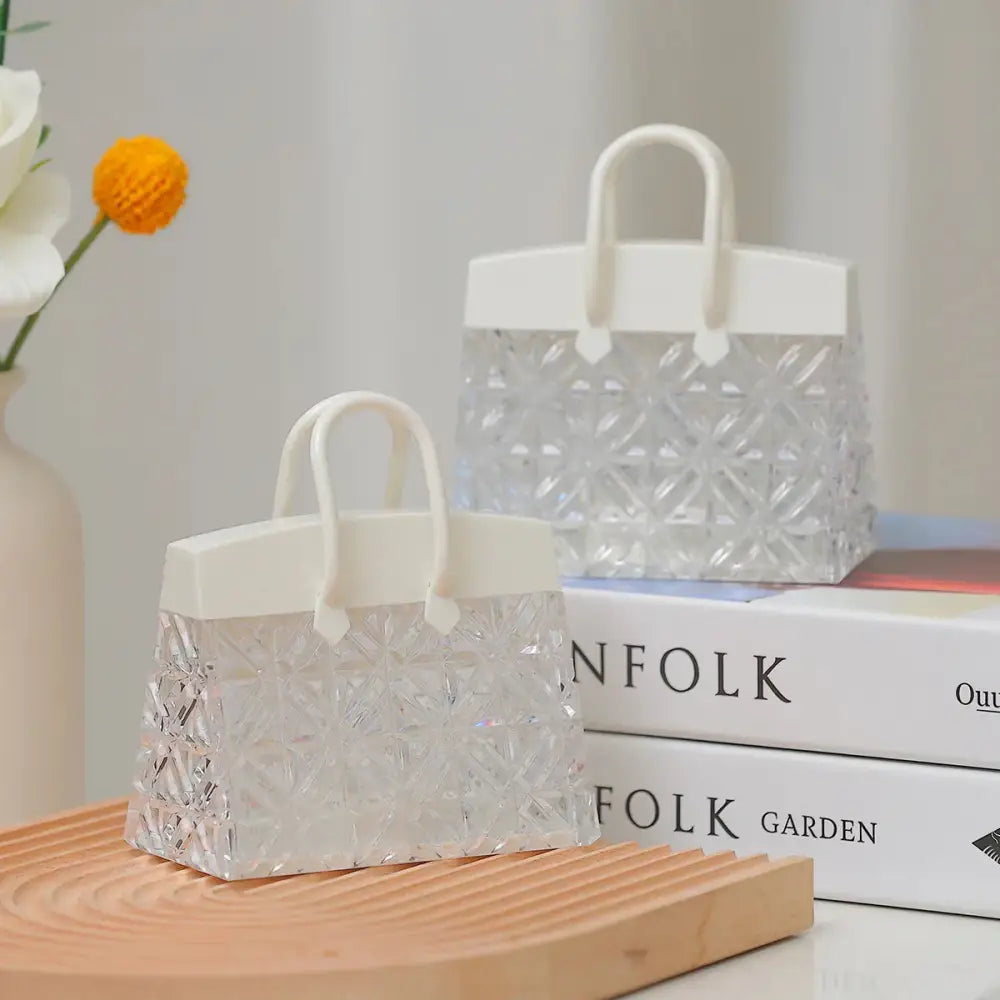 Clear geometrically patterned acrylic handbag with white handle and top flap featuring warm led night lamp glow