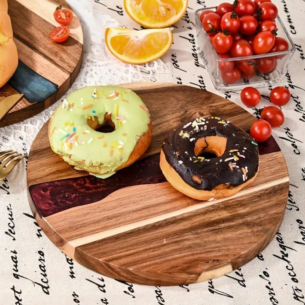 Teal resin river round wooden charcuterie board with marbled resin inlay on a natural wood serving surface