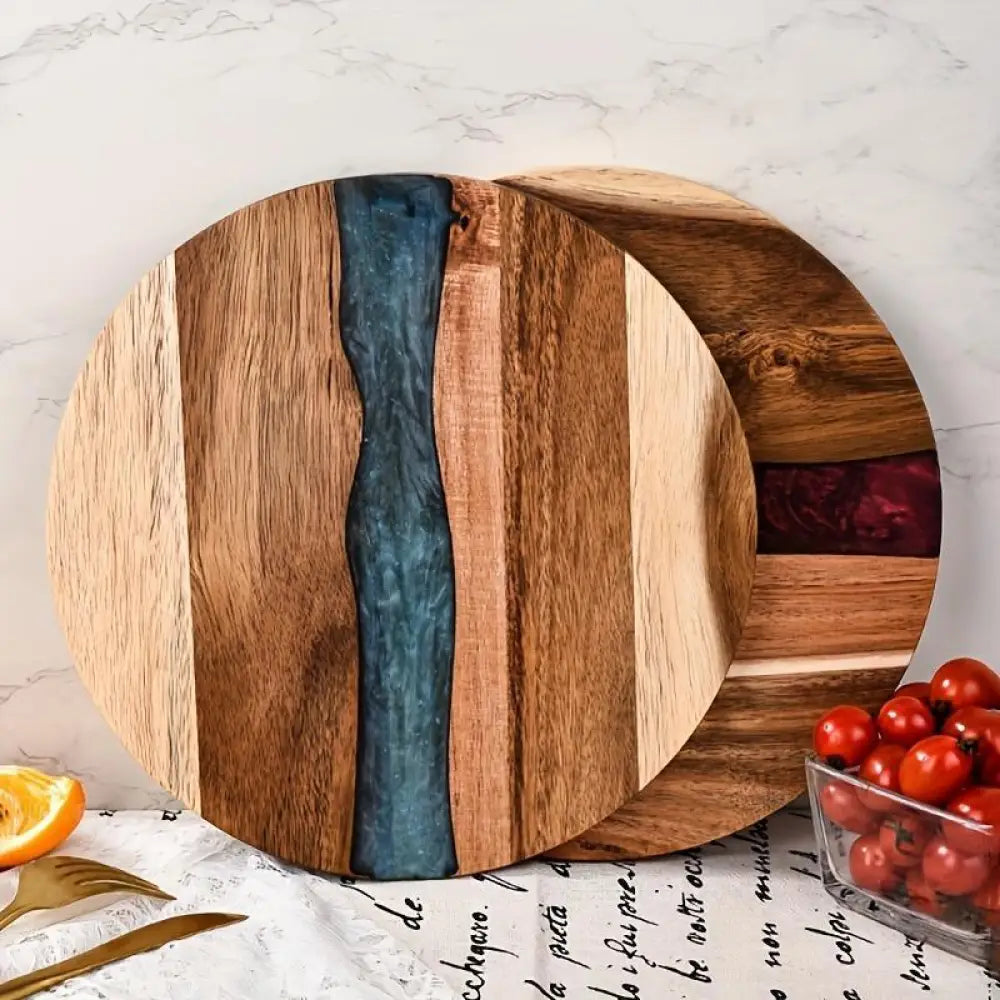 Teal resin river round wooden charcuterie board featuring light and medium-toned wood stripes and a dark teal resin river