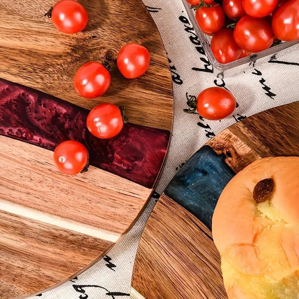 Teal resin river round wooden charcuterie board with maroon resin inlay and natural wood grain finish