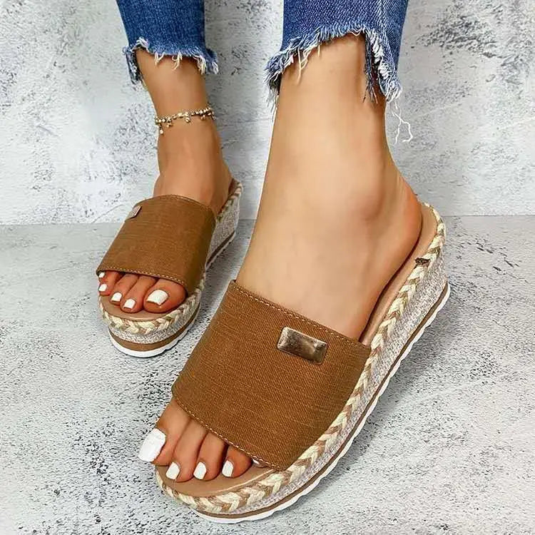 Brown canvas platform wedge espadrille sandals with a woven heel and metallic rectangular buckle detail.