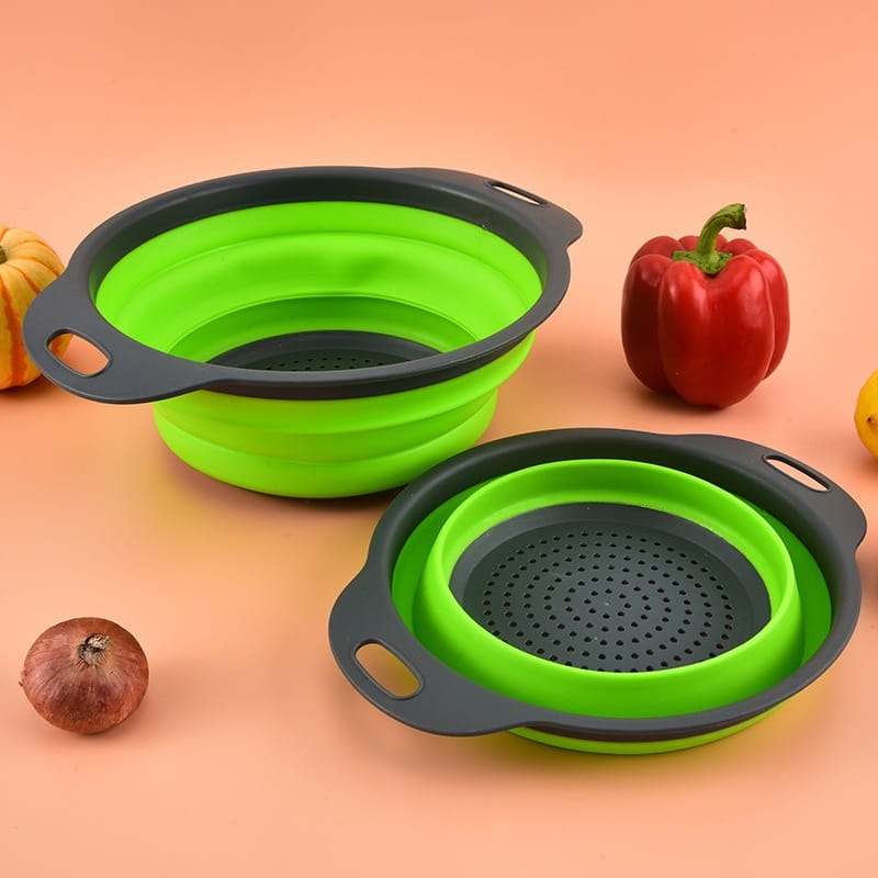 Bright green and black collapsible silicone colander with a perforated base for efficient draining in a collapsible silicone colander set drain basket.