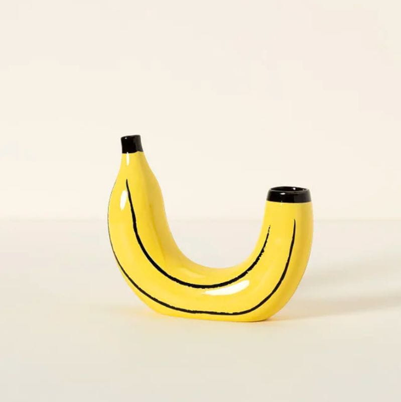 Yellow ceramic banana-shaped vase with black painted lines and caps for fruit shaped home decor.