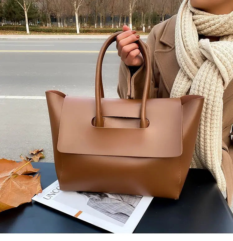 Brown leather vintage structured tote bag with top handles and a structured shape for everyday use.