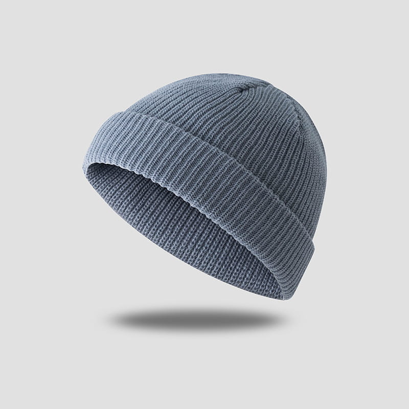 Dark gray ribbed wool beanie hat featuring a soft, muted gray knit texture.