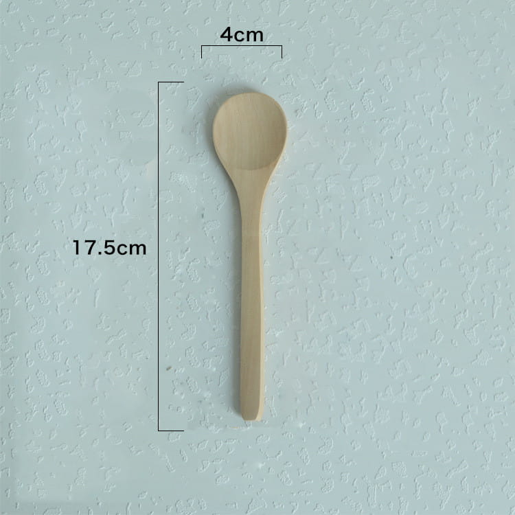 A light beige wooden spoon with a smooth rounded bowl and slender handle in a natural eco-friendly kitchen utensils wooden spoon set.