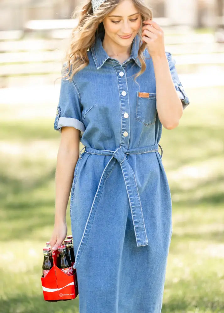 Blue denim midi dress with button front, rolled sleeves, and tied waistband featuring Ada Denim style
