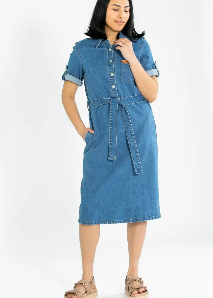 Ada denim button front midi dress features blue denim fabric with a belted waist and rolled-up sleeves