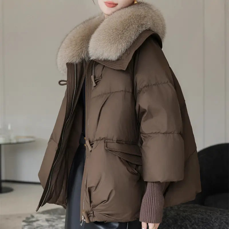 Women short fur collar down puffer jacket in brown with a plush light beige fur-lined hood and quilted design.