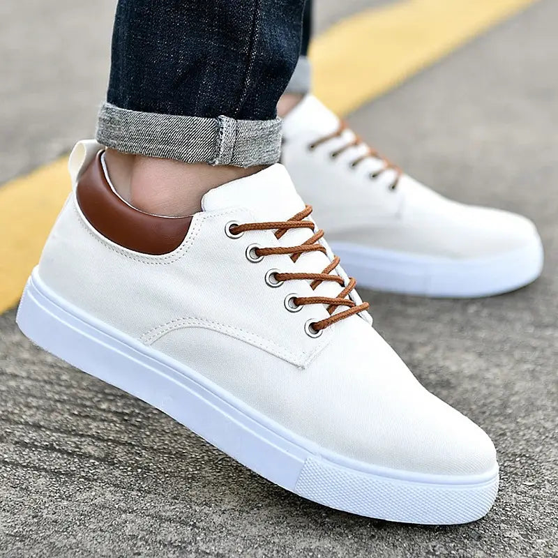 men’s breathable casual sport canvas sneakers in white with brown laces and a tan leather heel tab