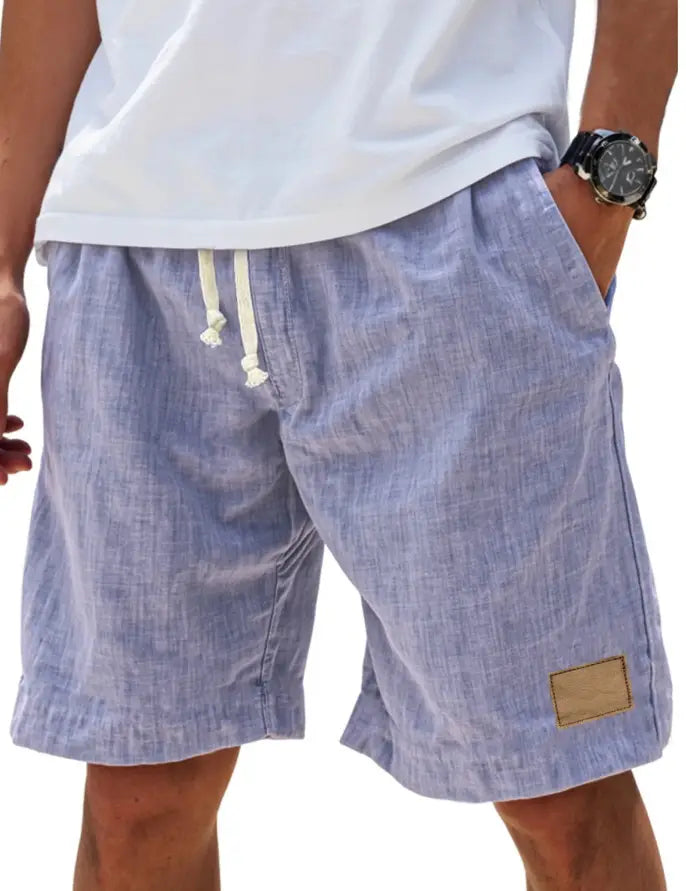 Light blue textured linen men linen holiday shorts with white drawstrings and a tan side patch featuring a breathable loose fit and retro style.