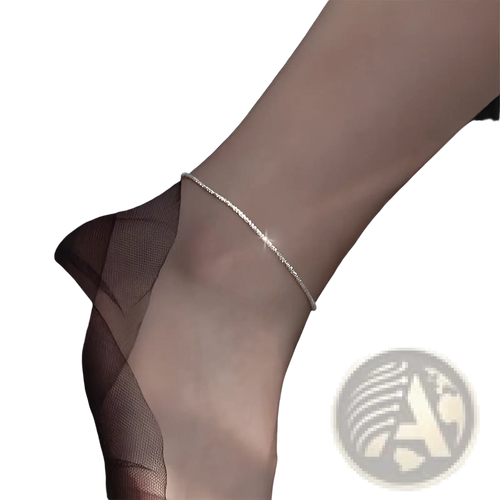 A delicate adjustable 925 silver sparkling crystal anklet with a subtle textured pattern elegantly wrapped around the ankle