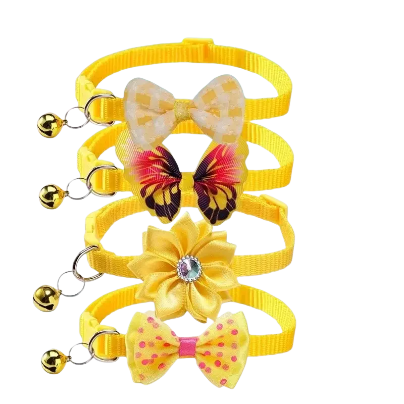 Set of four bright yellow adjustable bow cat collars with small golden bells and unique decorative charms