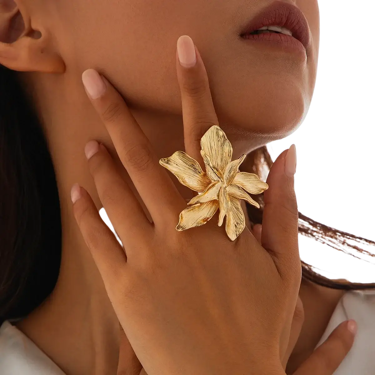 Adjustable double layer flower ring in gold with intricately detailed textured petals adorning a finger