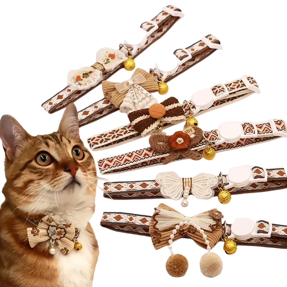 A collection of adjustable length floral cat collars with brown and cream fabric, embroidered bows, beads, and small bells