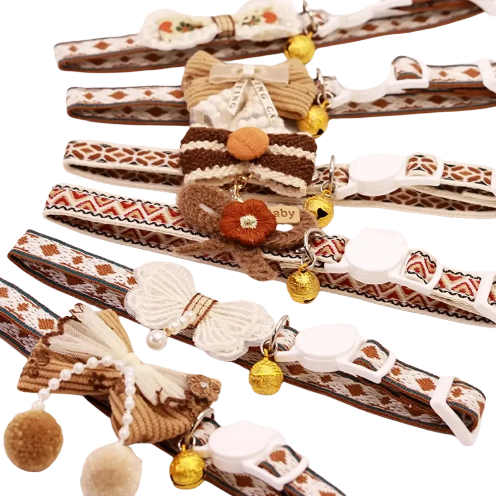 Adjustable floral cat collar with bell features patterned fabric, crochet bows, golden bells, and adjustable length design