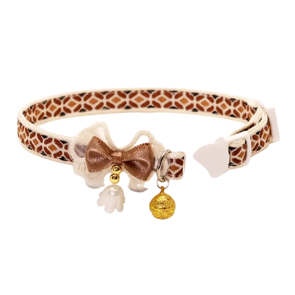 Adjustable length floral cat collar in brown and white with lace trim, gold bow, and dangling charms for cats