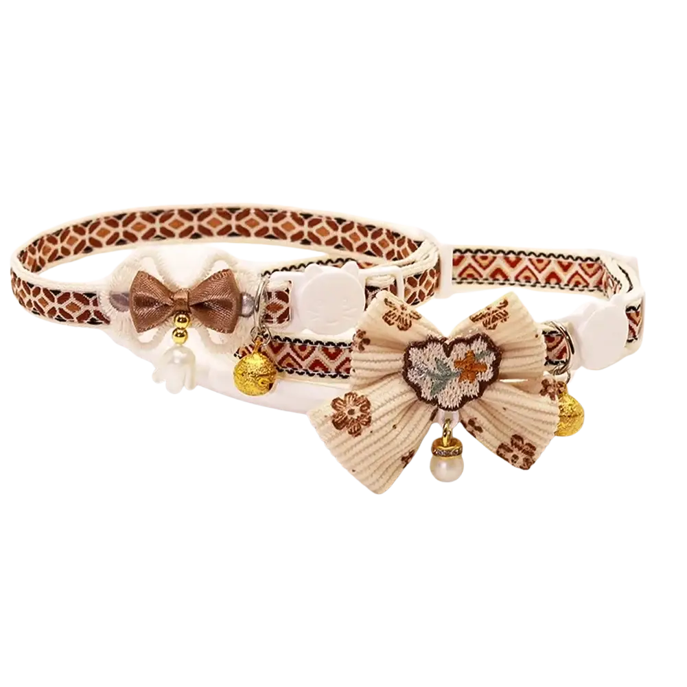 Adjustable length floral cat collars with bell featuring a brown satin bow and cream embroidered fabric bow with floral patterns