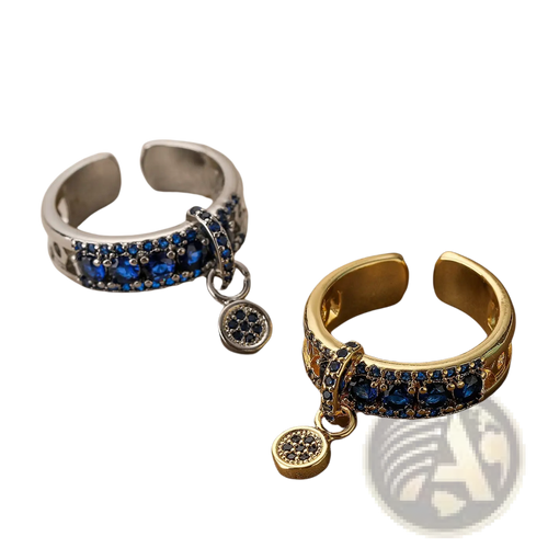 Two adjustable geometric open rings in gold and silver tones with blue zircon charms and deep blue gemstones