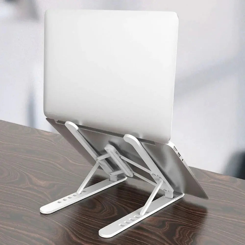 White adjustable 6-gear ergonomic cooling laptop stand supporting a silver laptop on a wooden surface