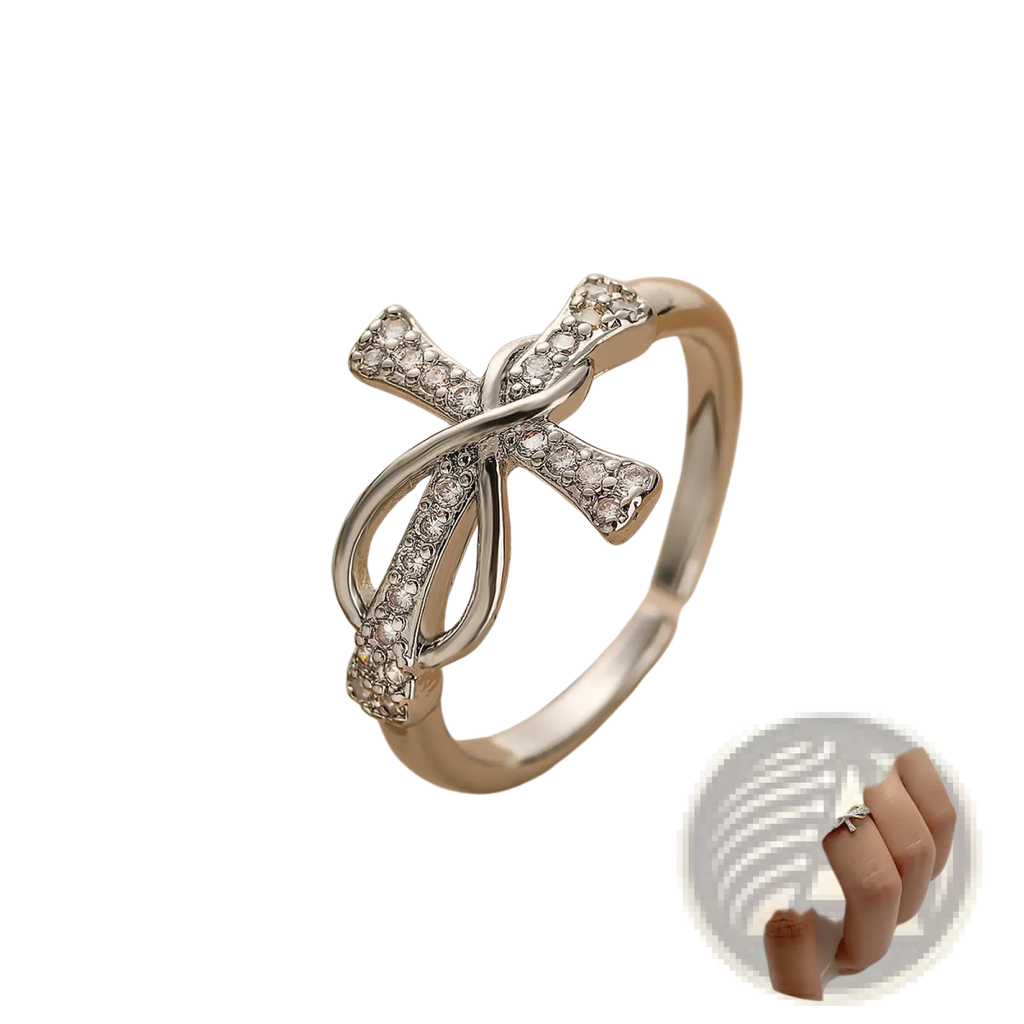 Adjustable silver cross and bow ring for women adorned with sparkling clear crystals in a delicate intertwined design
