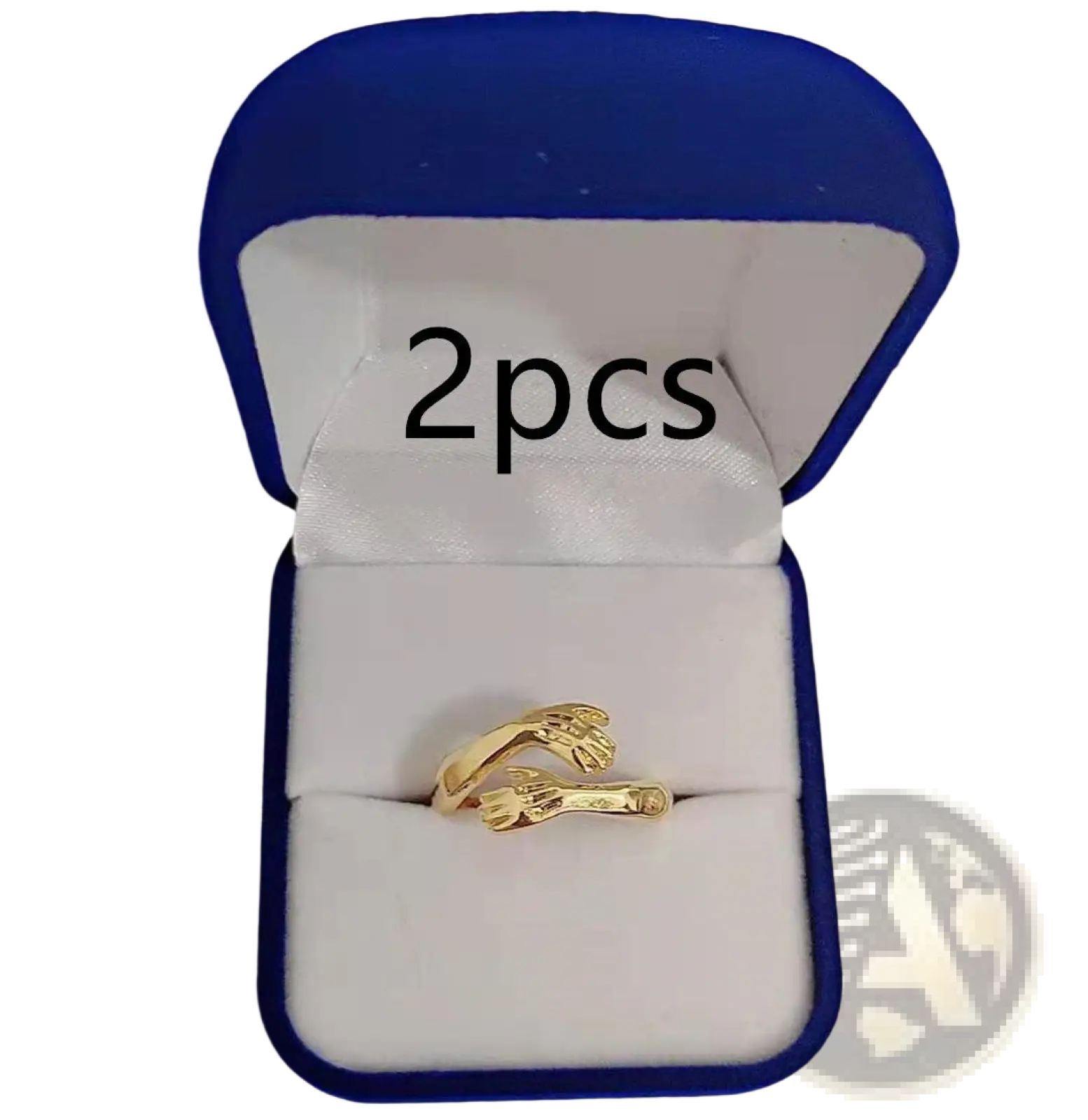 Gold-colored ring with an intricate design of two interlocking hands featuring a red gemstone centerpiece