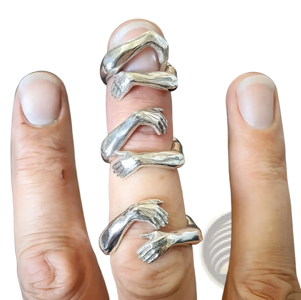 Adjustable silver ring featuring intricately designed intertwined hands with a polished finish and red gemstone